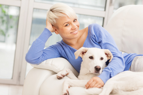 Dog parent relaxing with her dog at home